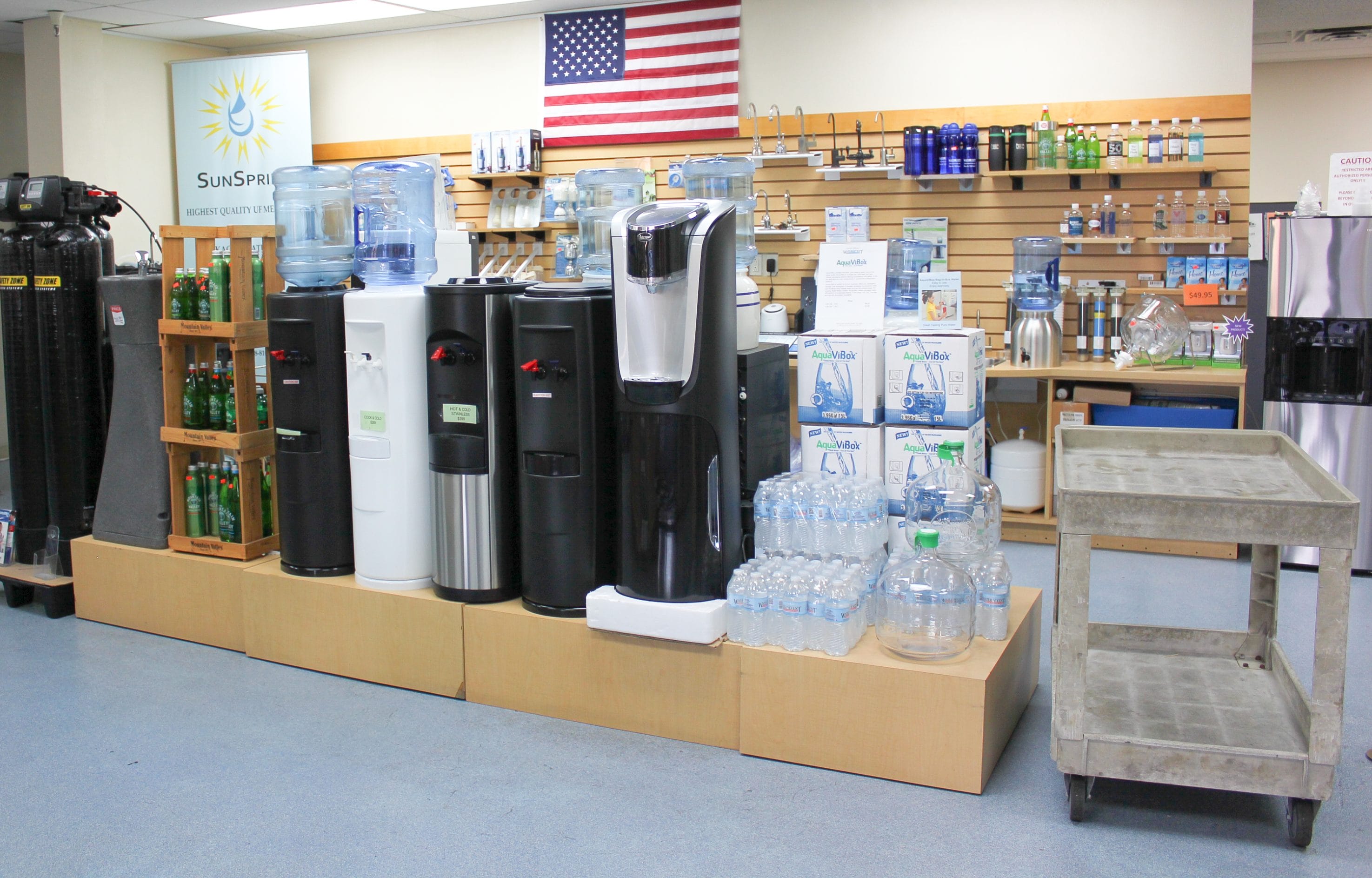 A line up of Texas Water House products (water jugs, filling stations, water products, etc.) on display in their showroom.