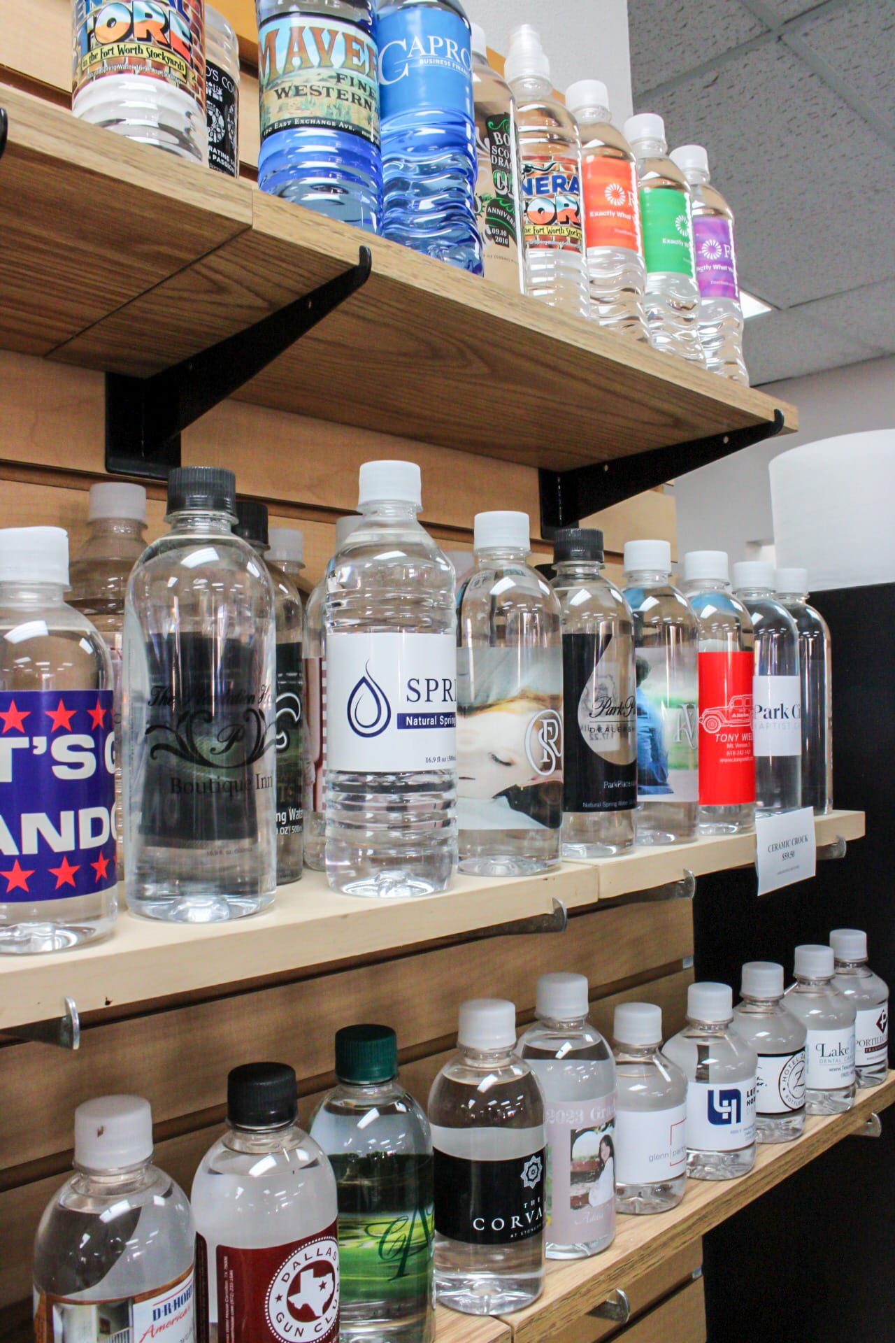 Rows of personalized water bottles sitting on a display shelf.