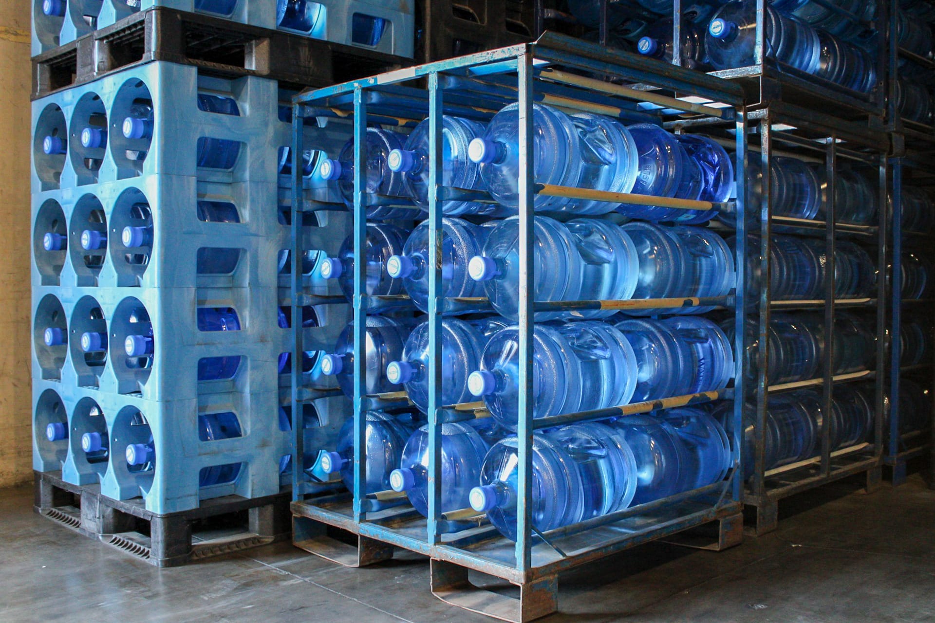 A couple dozen full water jugs that are stored in Texas Water House's facility.