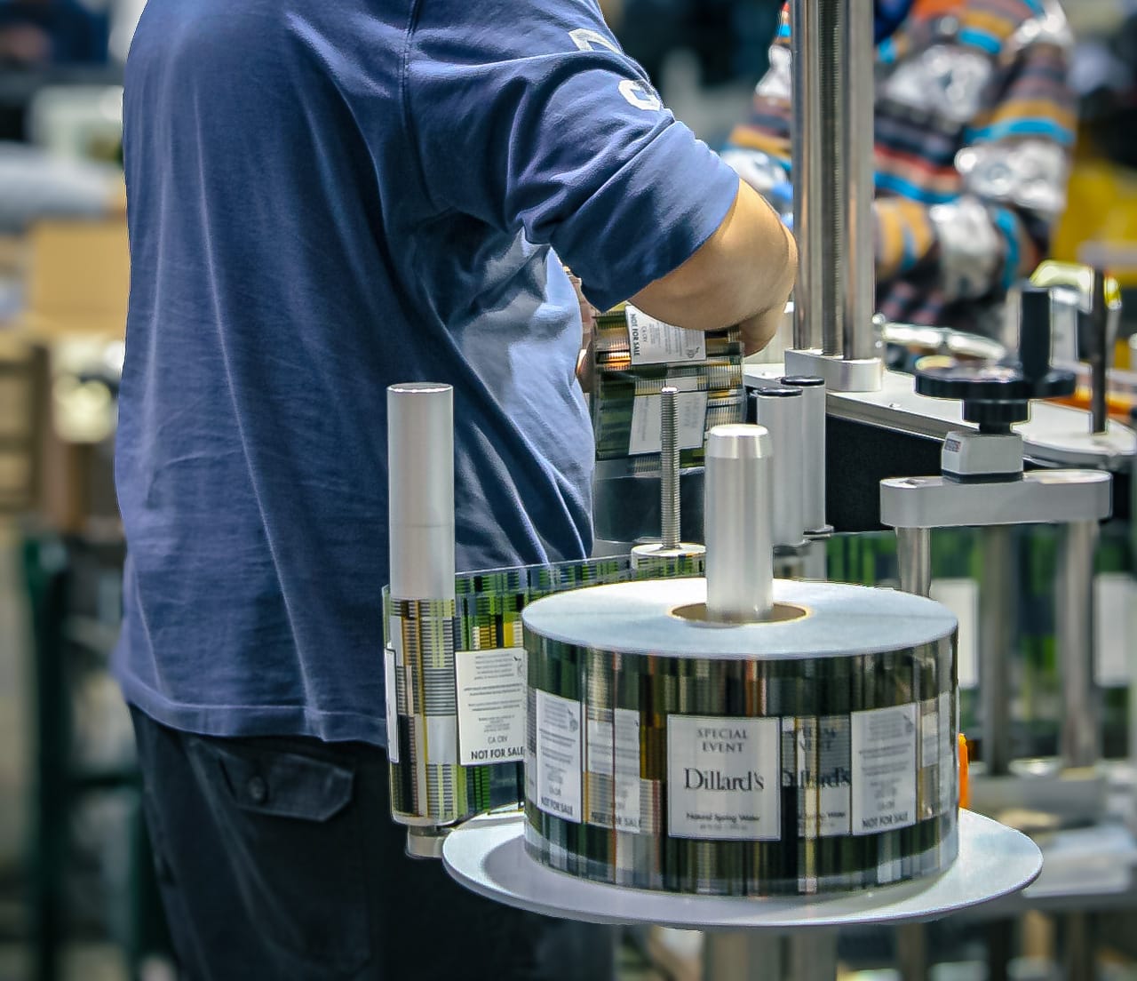 Texas Water House technician creating labels for custom water bottles.