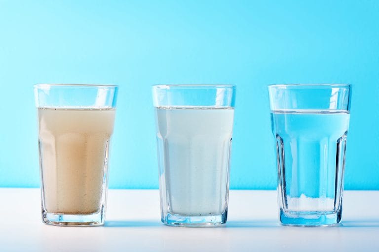 Stock Image of 3 glasses of water, ranging from very dirty to cloudy to clear.
